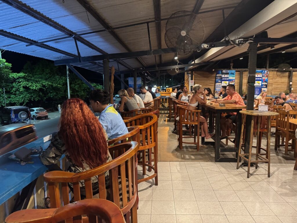 a group of people sitting at tables in a restaurant