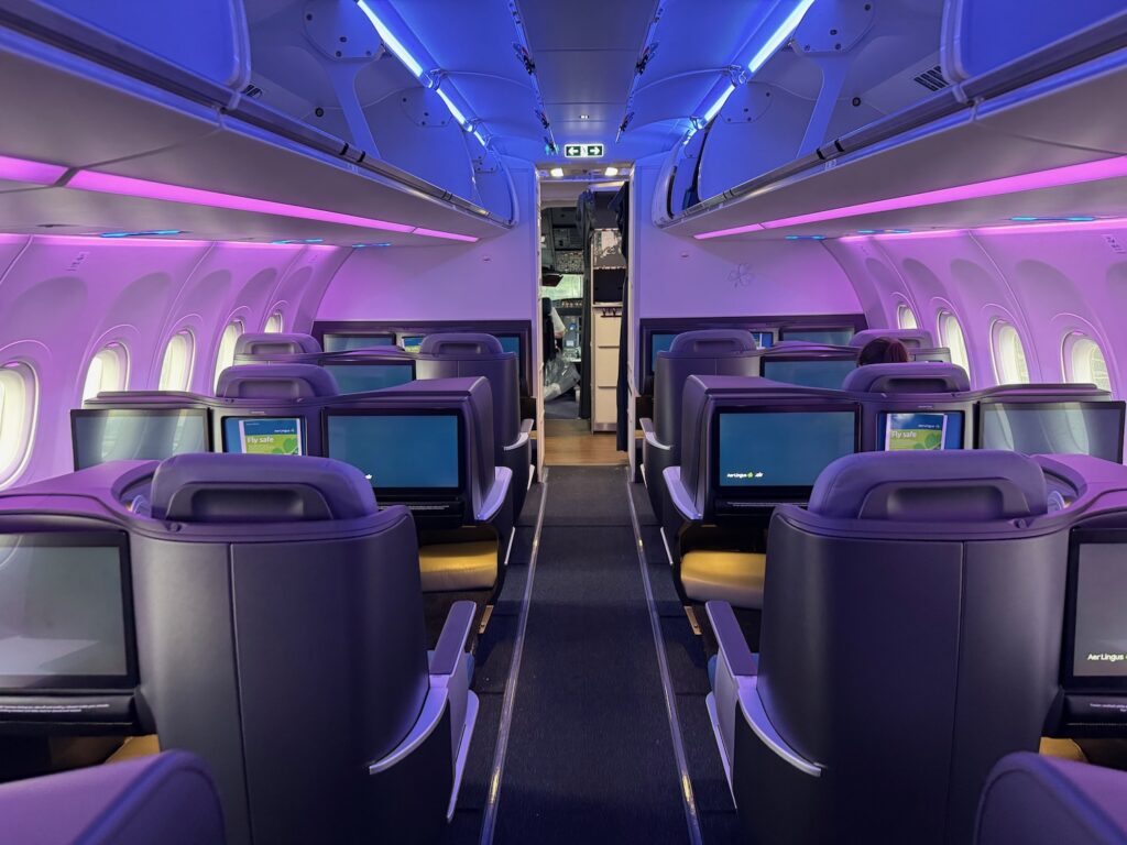 the inside of an airplane with purple lights