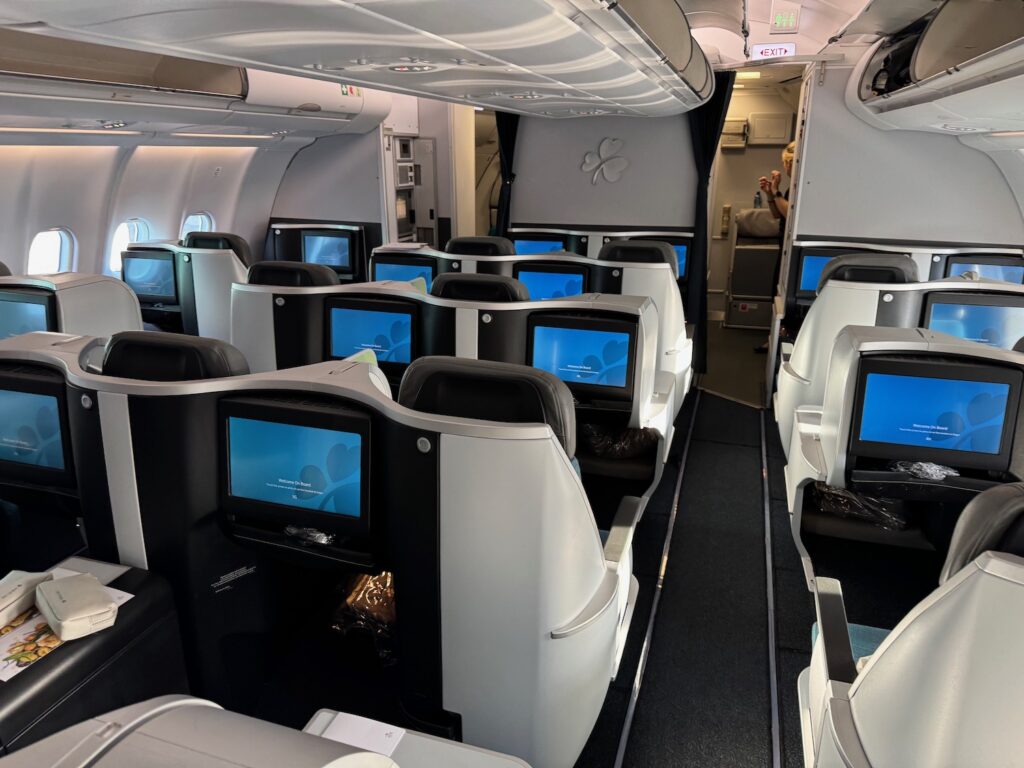 a row of seats with monitors on the side