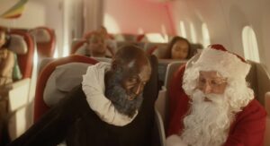 a man in a garment sitting on a chair next to a man in a garment