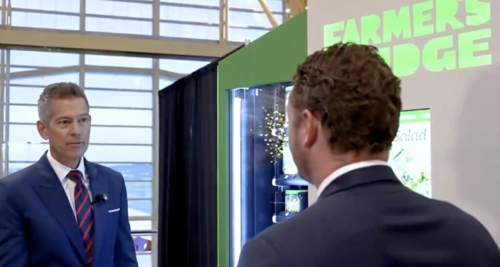 a man in a suit looking at another man