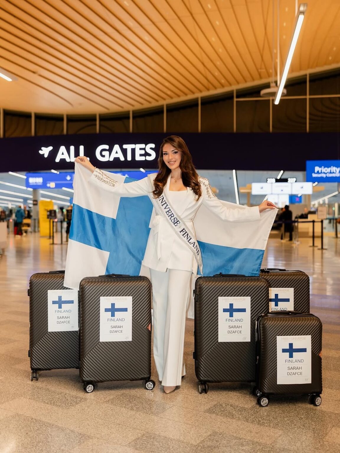 a woman standing in front of several luggage