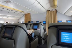 a person sitting in a chair with a book on the back of the seat