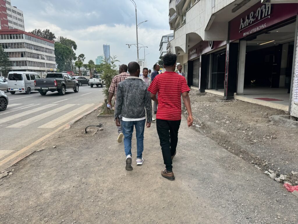 a group of people walking down a street