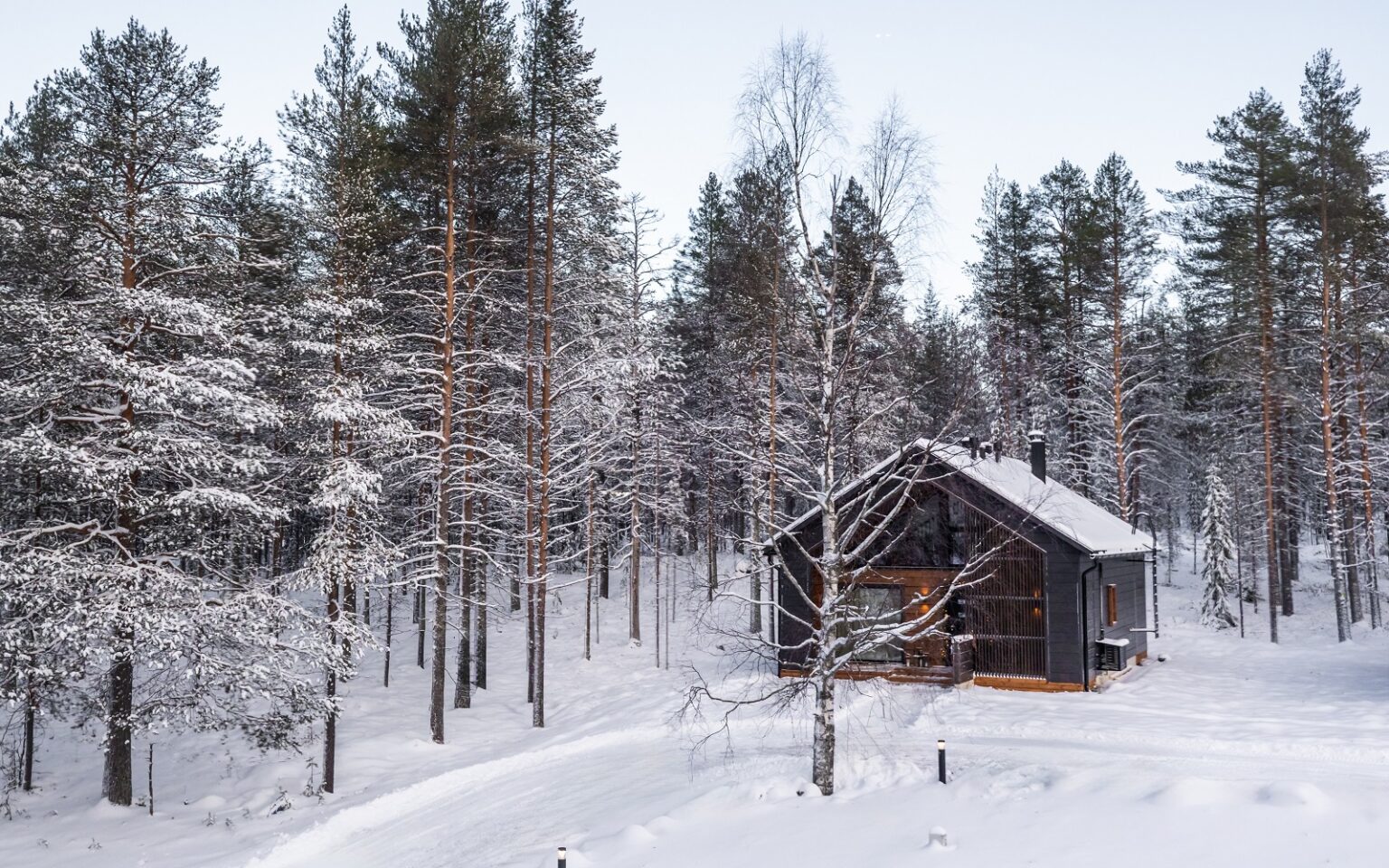 Skýra Retreat – an intimate Nordic hideaway in Finnish Lapland log cabin in snow and woods - Skyra retreat log suite