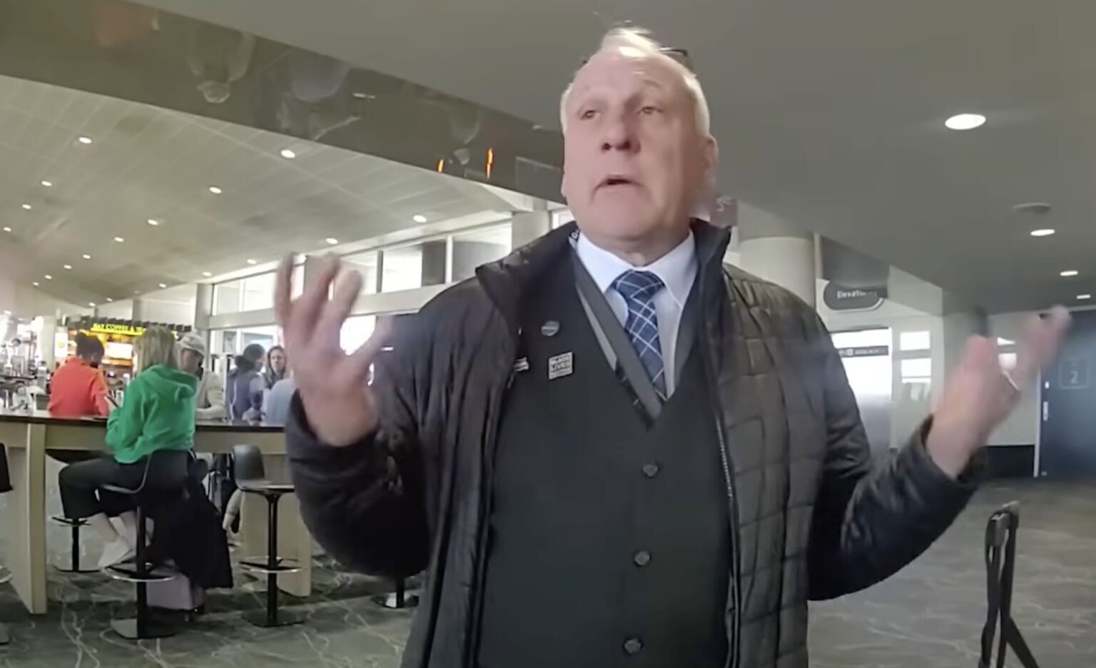 a man in a black coat and tie