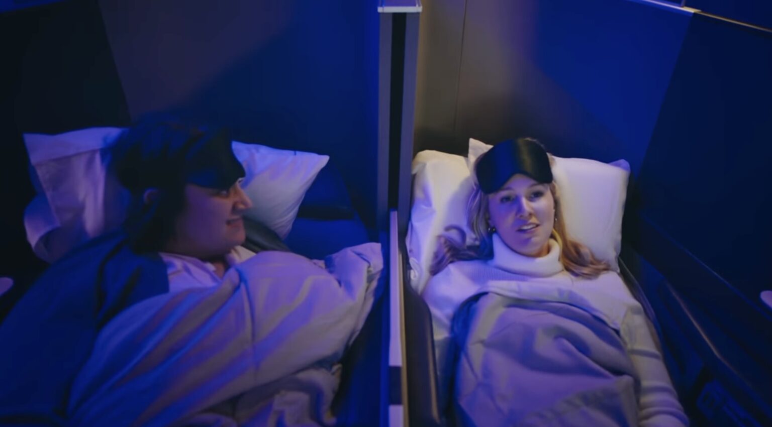 a man and woman lying in bed with sleeping masks