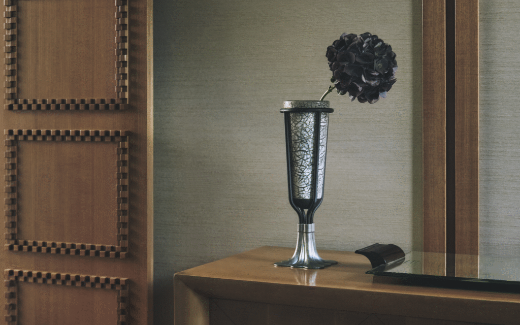 Palatino celebrates 10 years of design innovation vase on wooden surface with single black flower