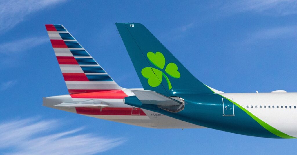 the tail of an airplane with a clover on it