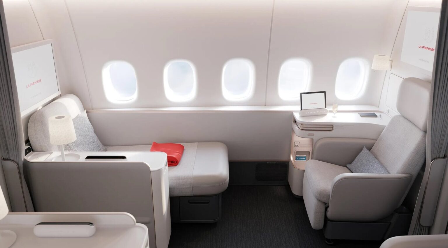 7 First Class Products I Hope To Fly In 2026 a seat and table in a plane