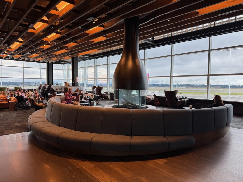 a large round couch in a room with large windows