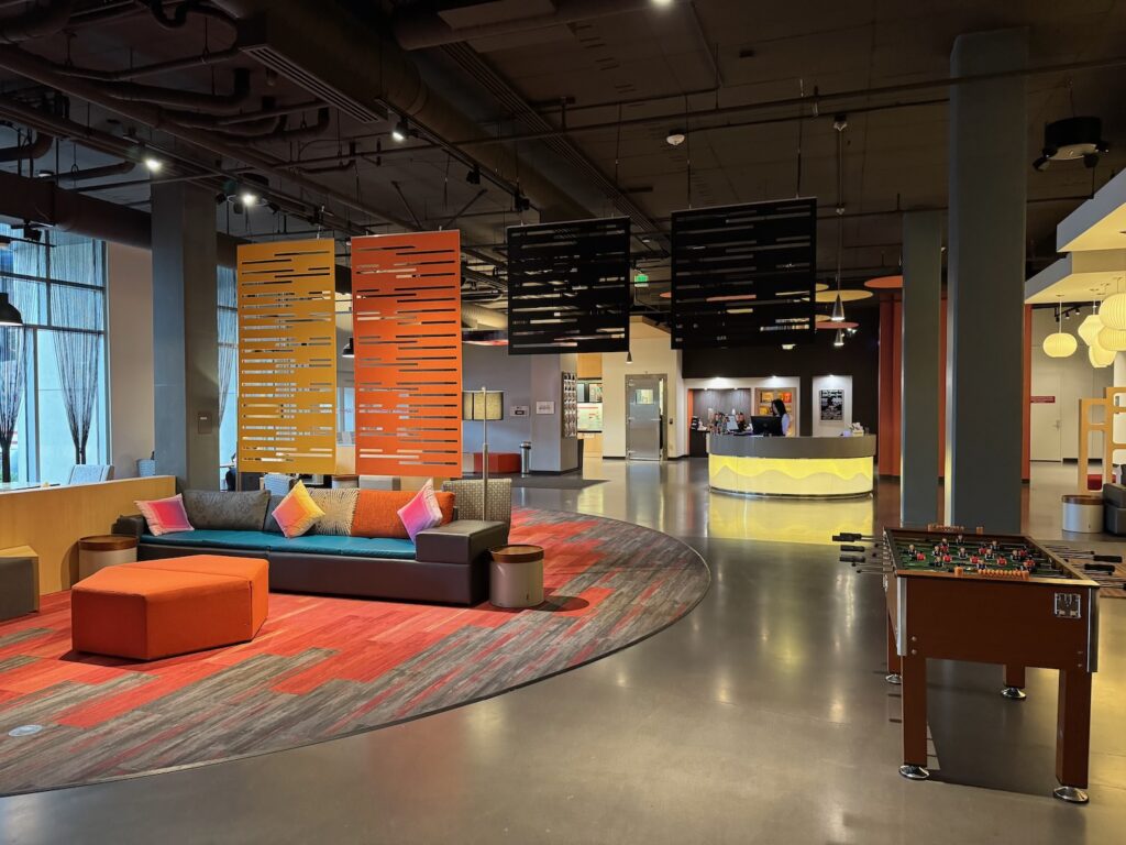 a room with a pool table and couches