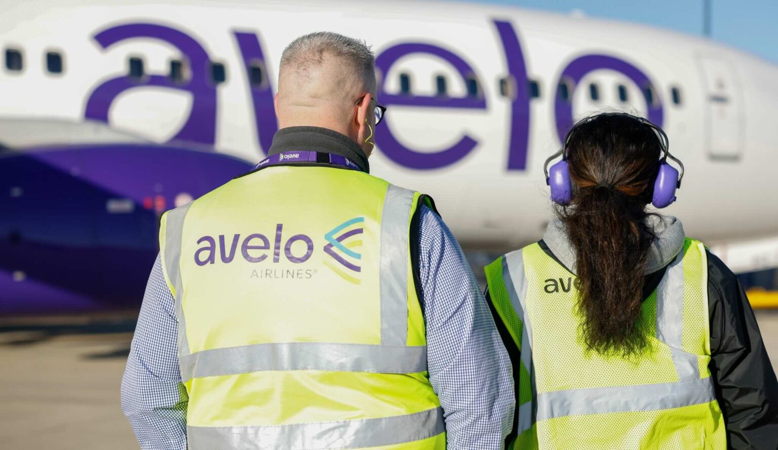 a man and woman wearing safety vests