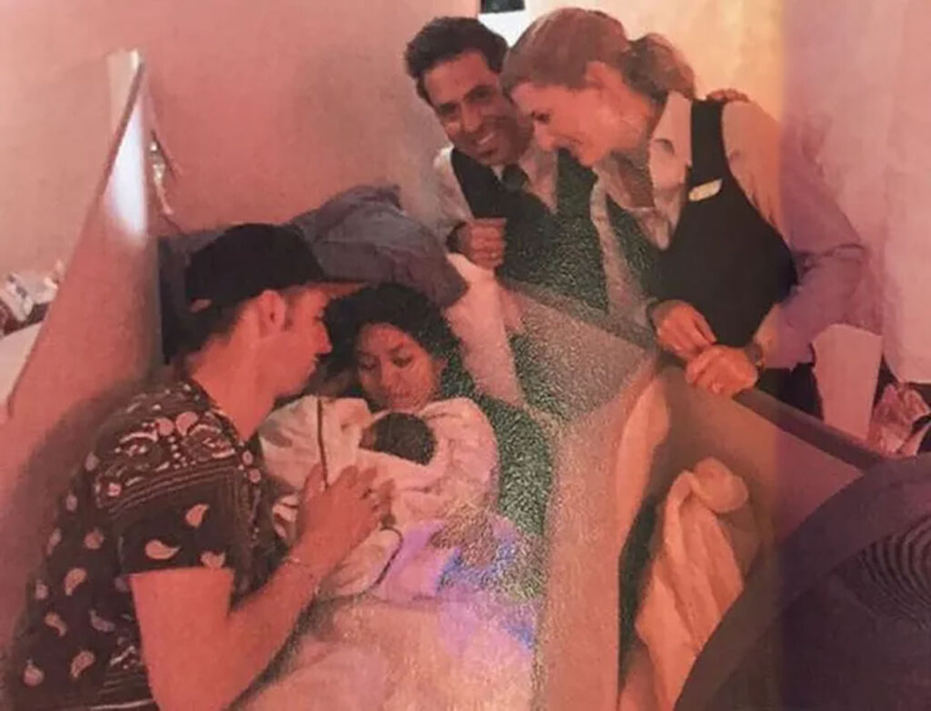 a group of people around a baby