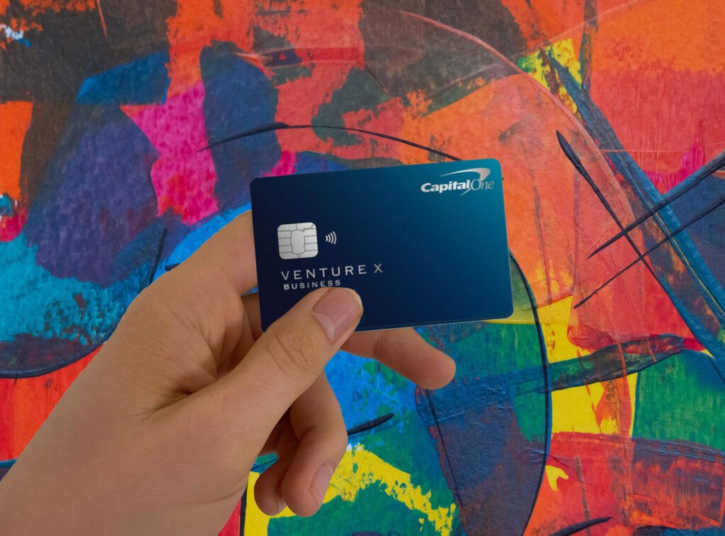 a hand holding a credit card