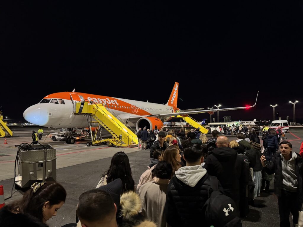 a group of people standing around an airplane