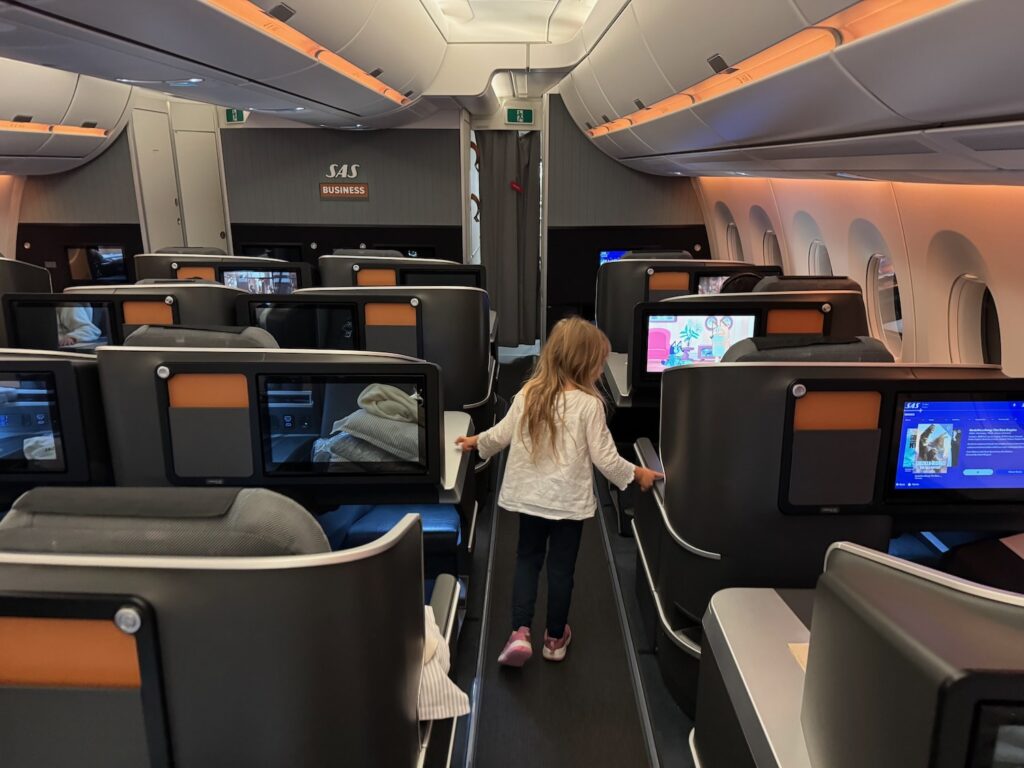Christmas Eve In The Sky: Flying SAS Business Class To Copenhagen a child standing in an airplane