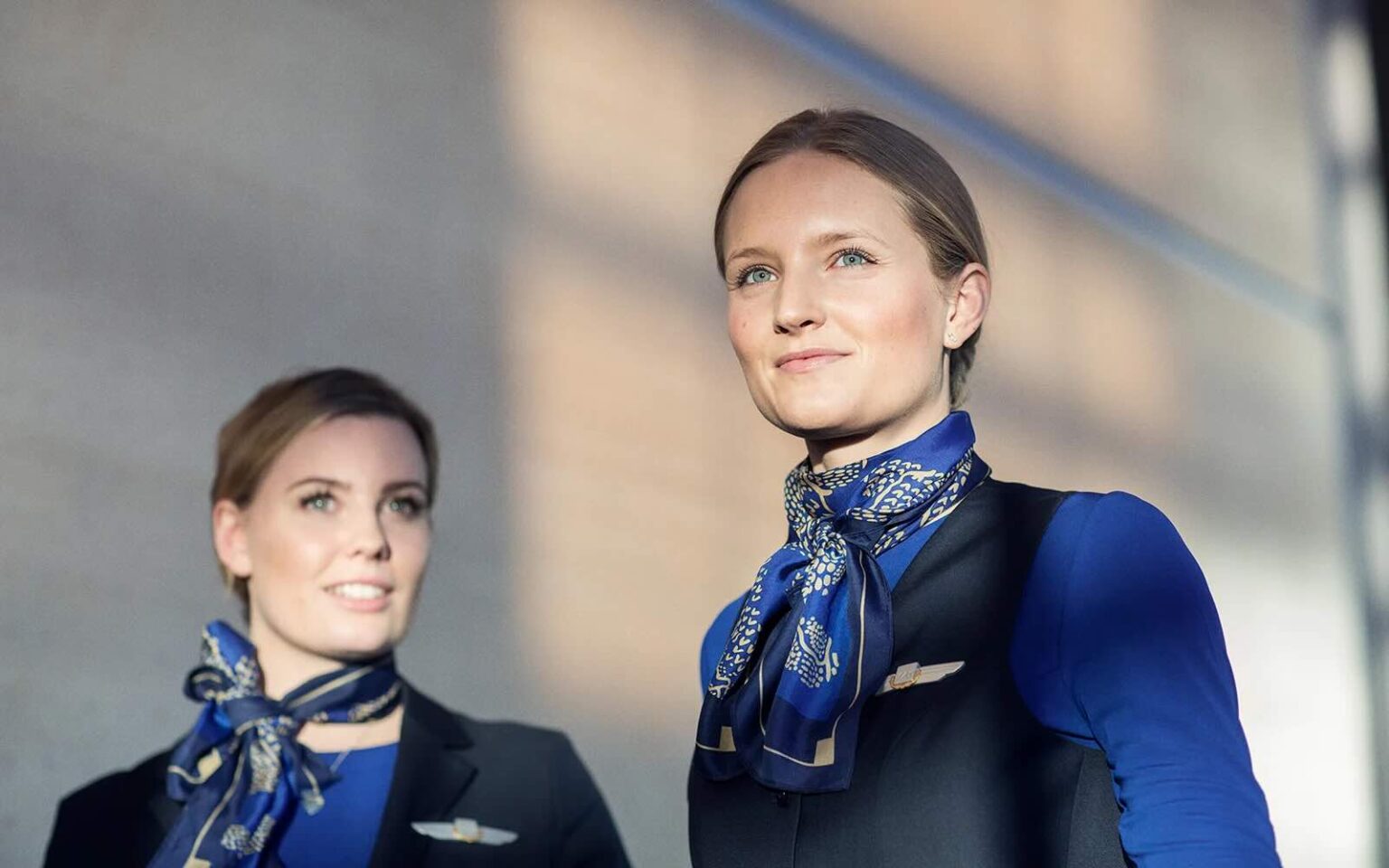 a couple of women wearing blue and black uniforms