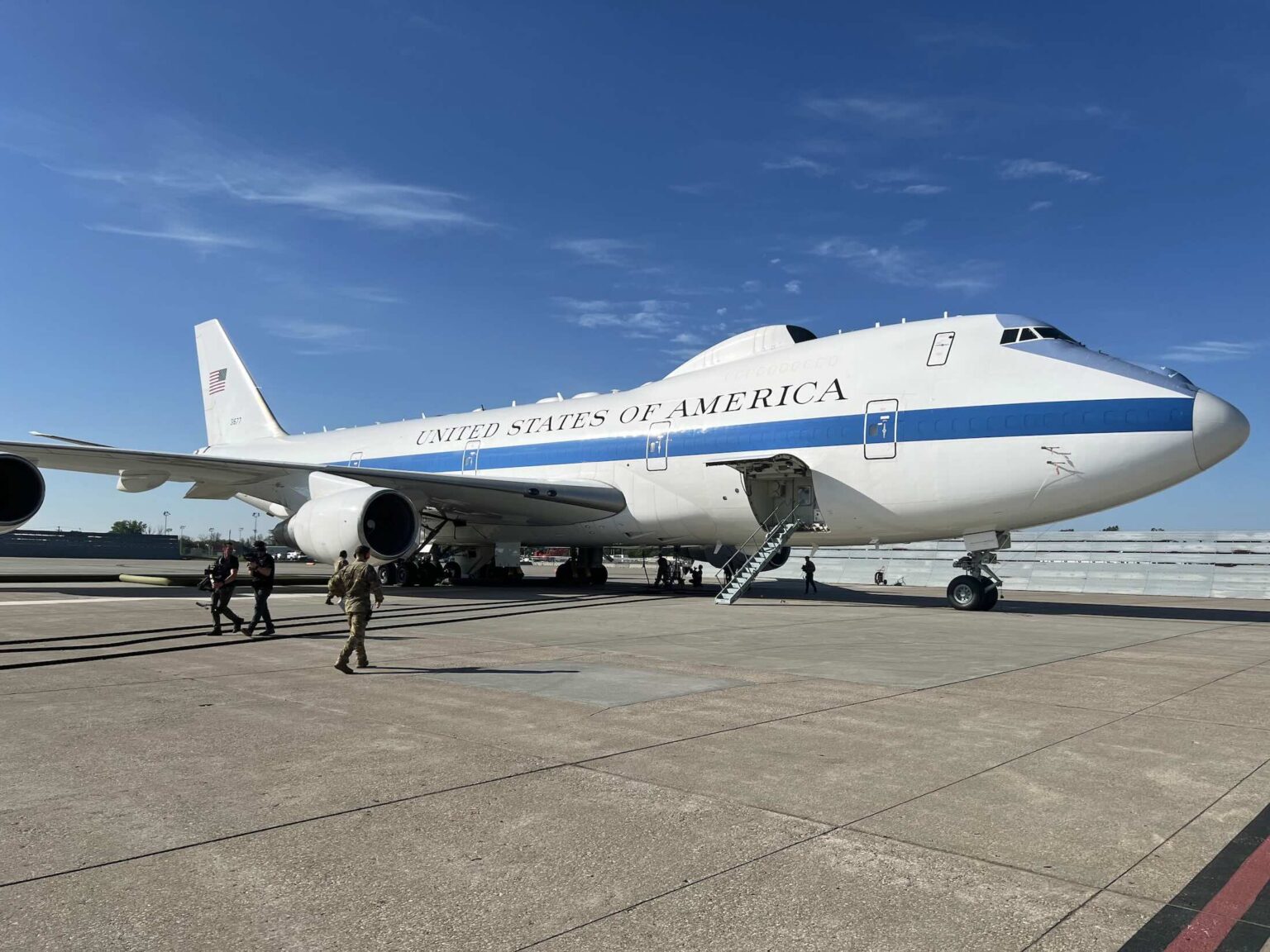 a white airplane with blue stripe on it