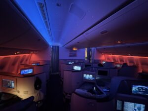 13.5 Hours in EVA 777-300ER Business Class… an airplane with a row of seats and a television