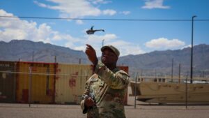 a US Army solider launches a drone from Fort Bliss