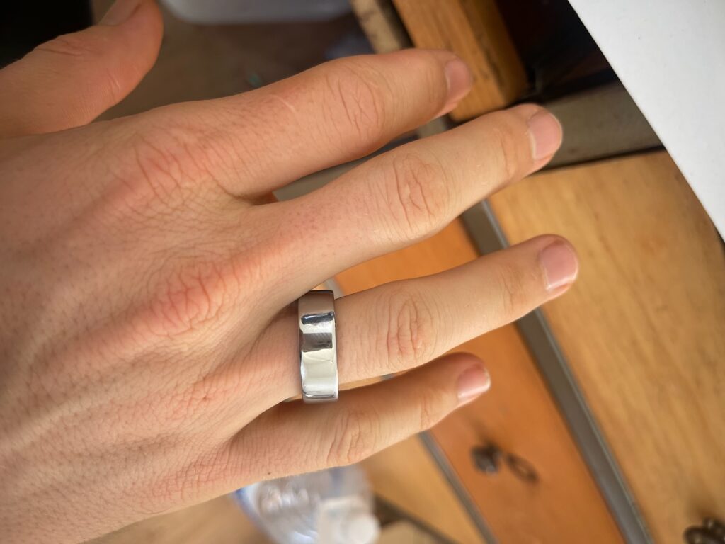 a hand with a silver ring on it