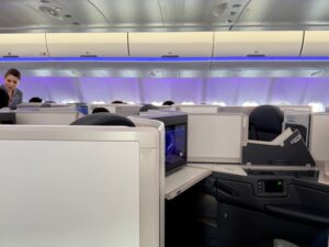 A Note To The Newlyweds In Business Class On My Malaysia Airlines Flight a row of seats with a television on the side