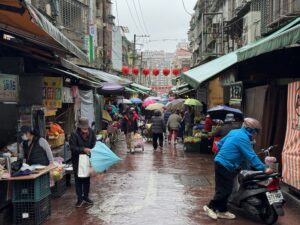 a group of people walking down a street with umbrellas