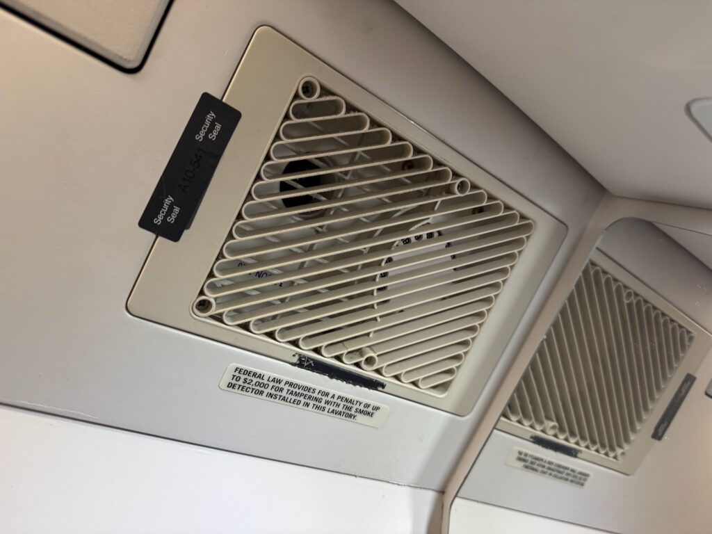 Brilliant: Passenger Smokes In Lavatory On My United Flight And Sets Off Alarm a white vent on a wall