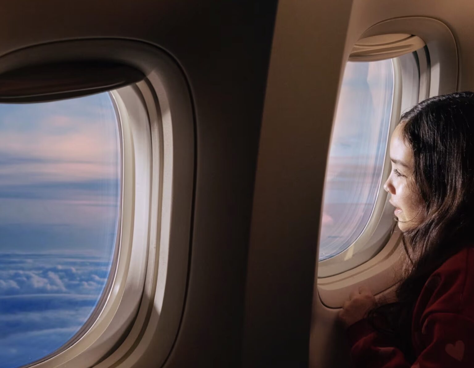 a woman looking out the window of an airplane