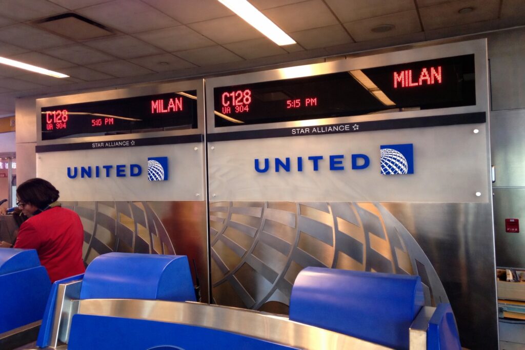 Serial Stowaway Slips Onto United Transatlantic Flight, Makes It All The Way To Italy a sign on a wall