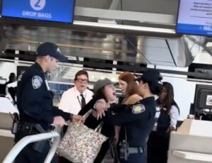 VIDEO: Woman Tackled By Port Authority Police After Meltdown At American Airlines Counter At LaGuardia a group of people in uniform