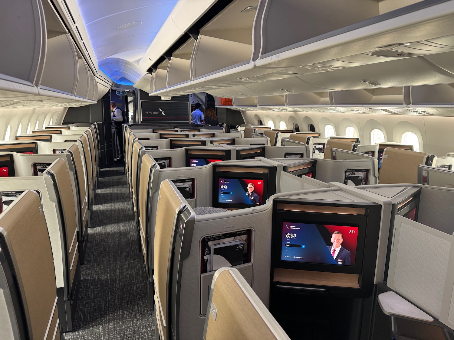 a row of seats with monitors on the side