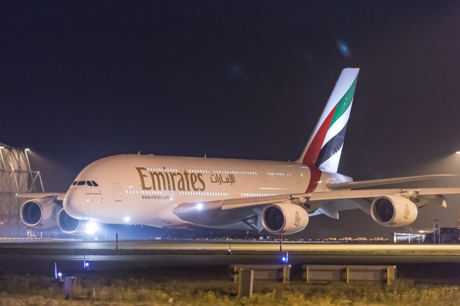 Iranian Drone Hits U.S. Consulate In Dubai As Emirates Flight Restart Spirals Into Chaos an airplane on a runway at night