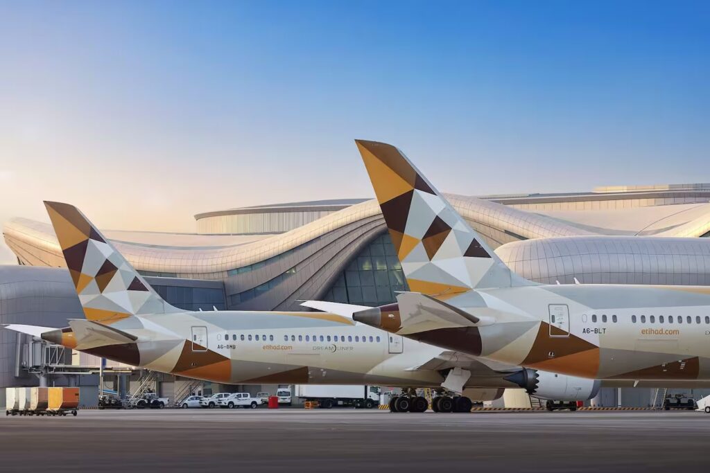 Etihad, Emirates Restart Flights As Qatar Airways Remains Suspended a large airplane parked in front of a building