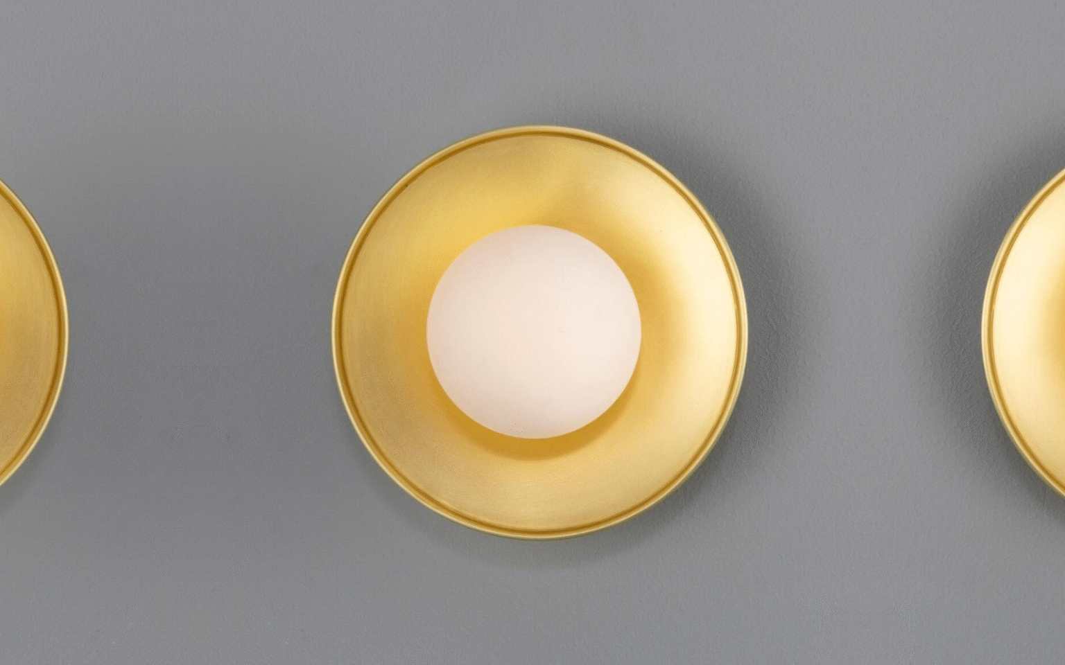 Lighting the modern hotel bathroom with Mullan Aosta Brass Disc Bathroom Wall Light with Glass Globe 16.2cm