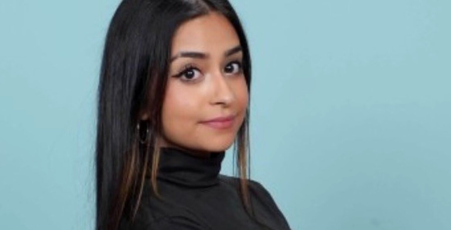 a woman with long hair wearing a black turtleneck