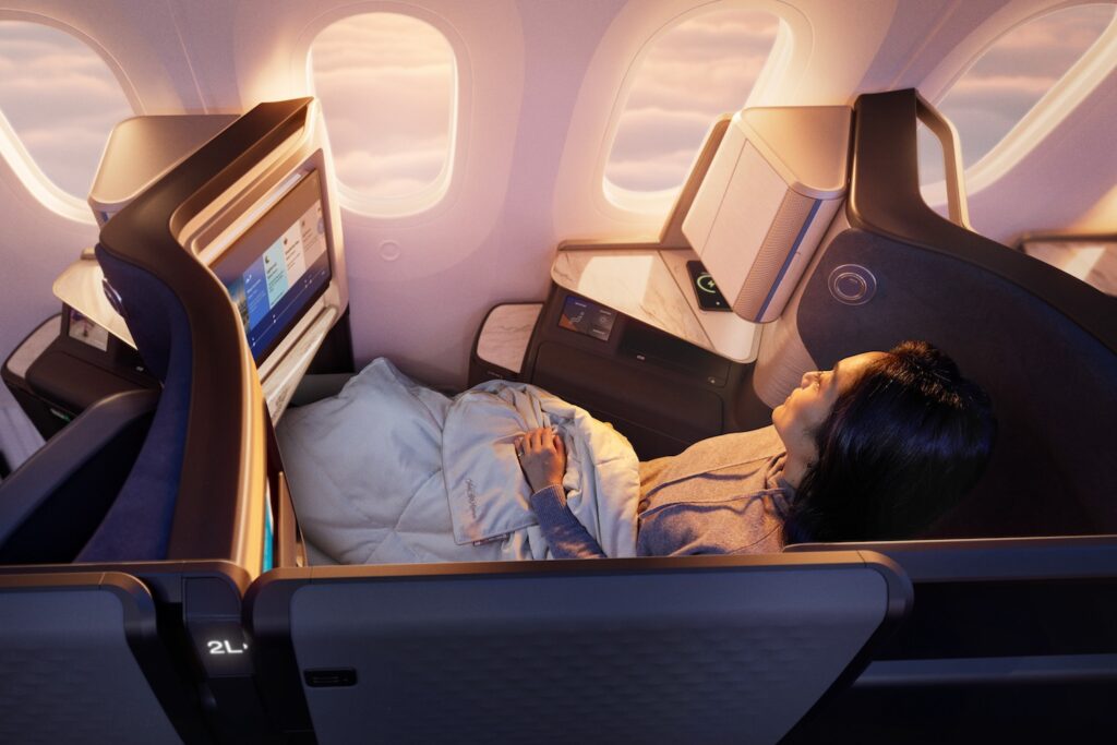 United Polaris Suite Doors Will Be Locked Open…For Now a woman in a plane