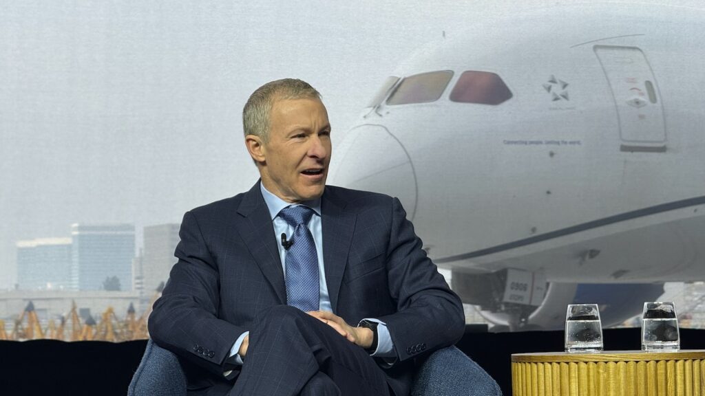 Scott Kirby United Airlines CEO speaking in front of aircraft backdrop