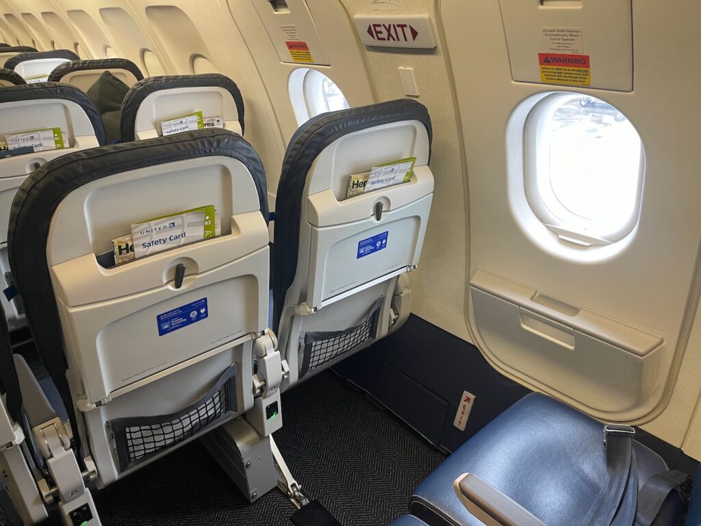 exit row laptop United flight
