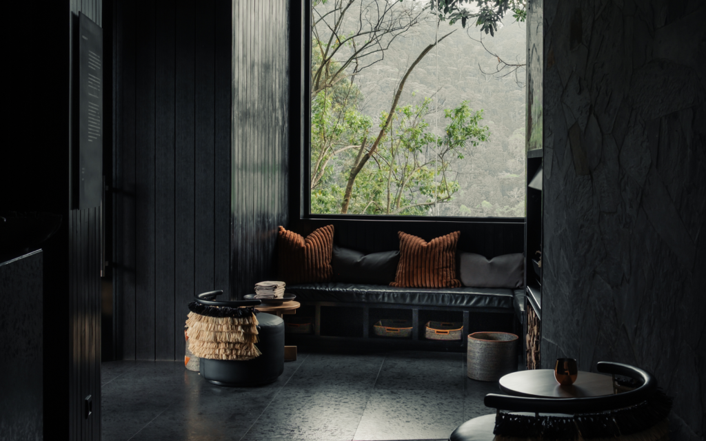 Uganda’s Silverback Lodge redefines contemporary safari conventions black walls and floors with view over rainforest at Silverback Lodge, Uganda