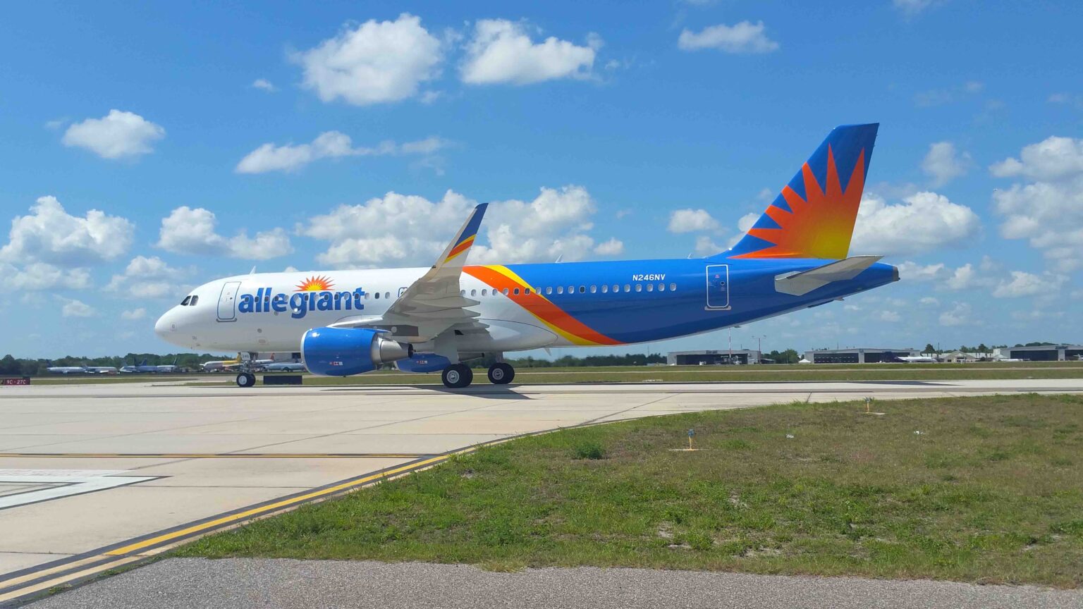 Allegiant Bought An Airline To Sell A Credit Card a blue and orange airplane on a runway
