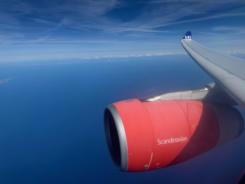 an airplane wing with a red engine