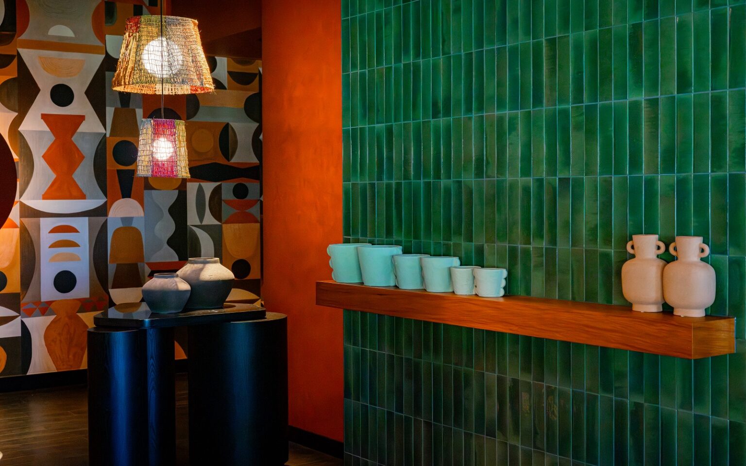 Salted Egg Darwin – a bold and immersive dining design green tiled wall - orange pillar - painted mural in Salted Egg Darwin