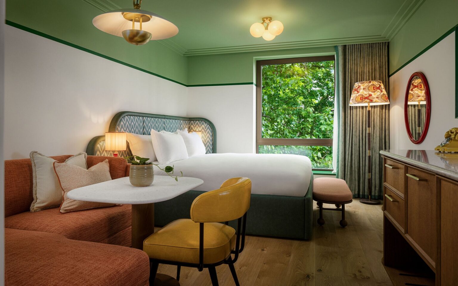 Case study: relaxing with Hypnos in The July London Victoria green ceiling and white wall and green headboard in the July with hypnos mattress