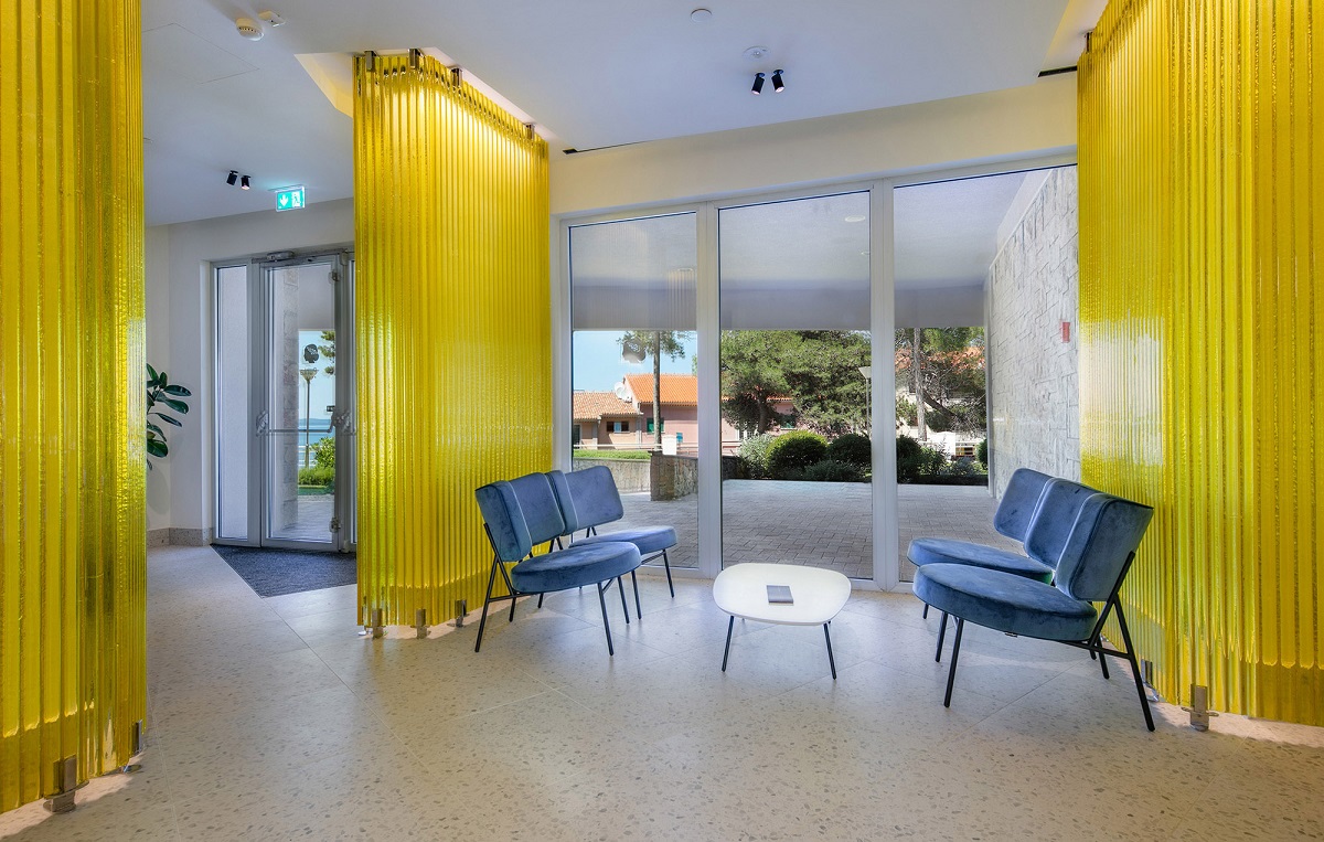 yellow glass panels divide zones, deliver lighting and make architectural statement