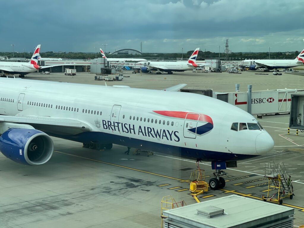 All Three British Airways Pilots Struck By Food Poisoning Midflight, One Incapacitated At 30,000 Feet a large white airplane at an airport