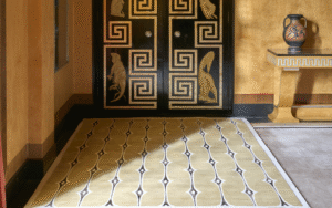 The Art of the Floor: how the right rug can transform a hotel interior Pelican carpet rug on the floor with ochre walls and decorative door