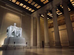 10 American Travel Experiences You Should Have At Least Once a statue of a man sitting on a chair in a large room with columns