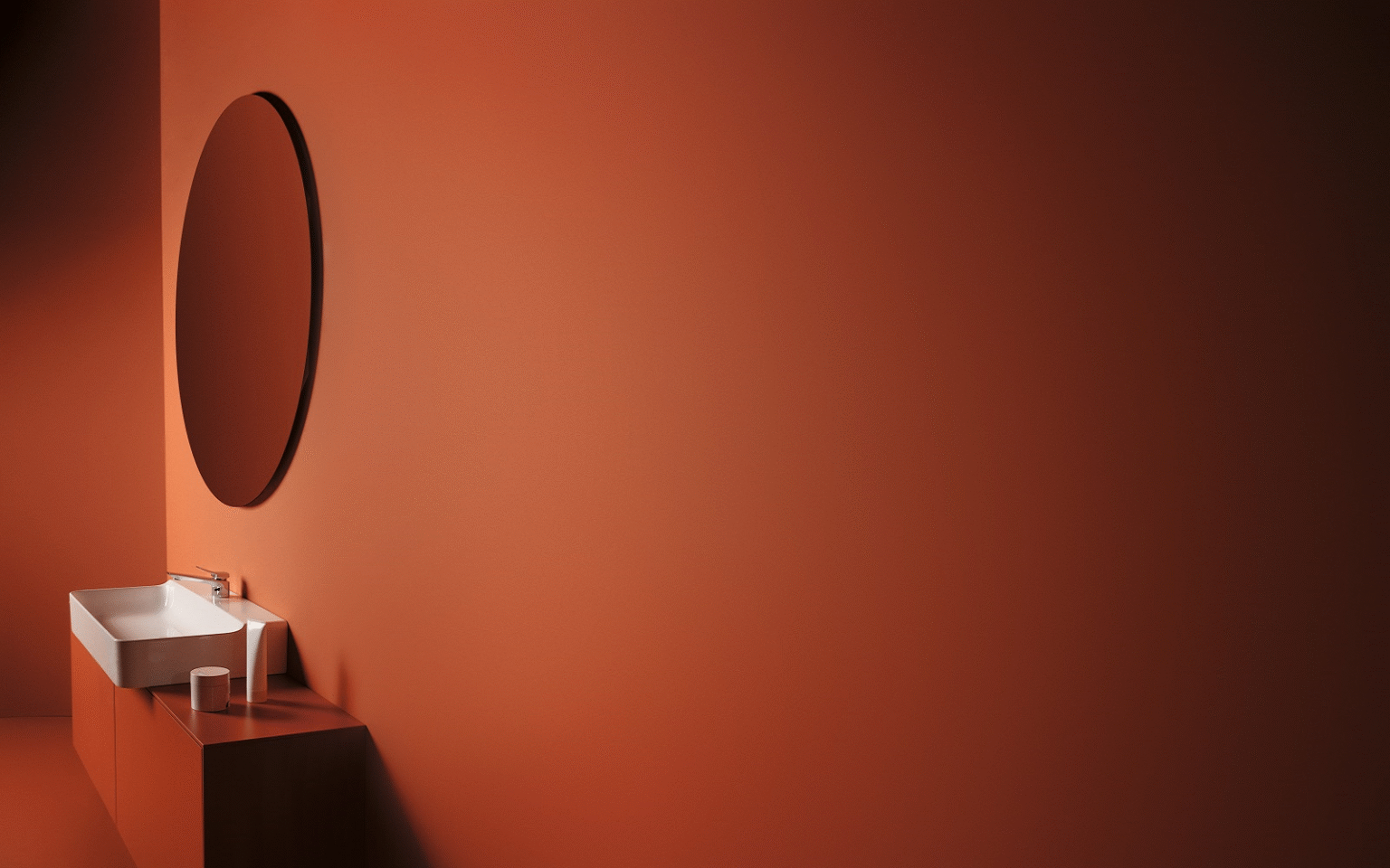 Conca Mirrors by Ideal Standard – illuminating luxury in modern hotel bathrooms conca mirror from Ideal Standard on rust painted wall